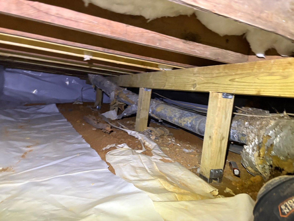 Rotted floor joist in a damp Atlanta crawl space before structural repair